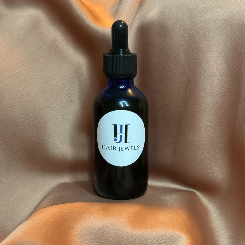 Hair Jewels Hair Growth Serum in amber dropper bottle on white background